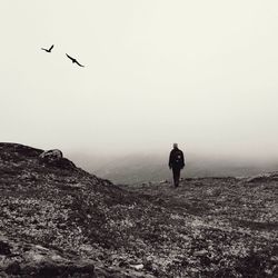 Full length of woman flying over landscape