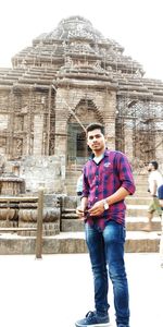 Full length of man standing against historic building