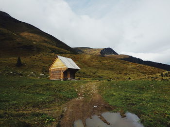 Scenic view of building and mountains against sky