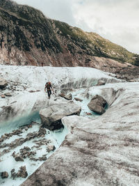 Scenic view of snow on rock against sky