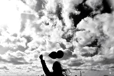 Low angle view of man playing basketball against sky