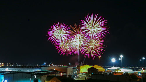 Firework display in city at night