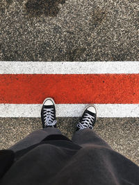 Low section of man standing on street