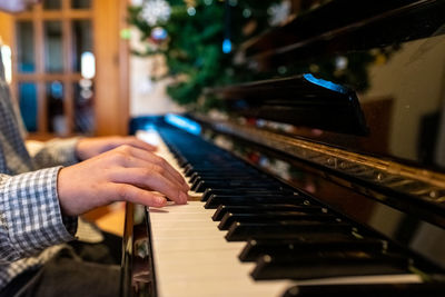 Midsection of man playing piano