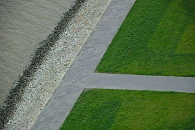 High angle view of road amidst green grass