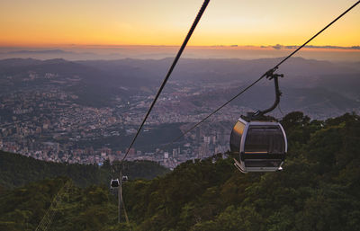 Modular cabins cable car against the bright sky, clouds ans mountains. cableway 