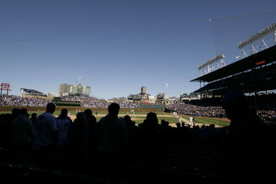 Crowd in front of city against clear sky