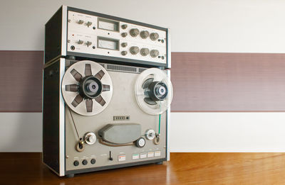 Close-up of recorder on table against wall