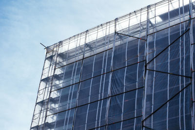 Low angle view of building in progress against sky