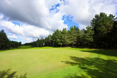 Scenic view of golf course against sky