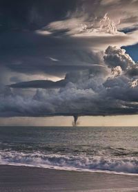 Scenic view of sea against storm clouds