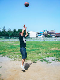 Young woman playing on field