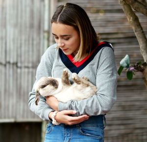 Young woman holding a horse