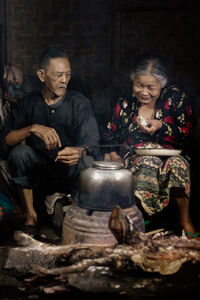 Portrait of man preparing food on barbecue grill