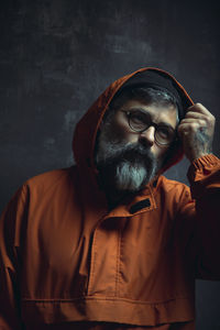 Portrait of man wearing hat against wall