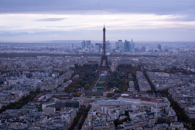 High angle view of city buildings against cloudy sky