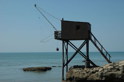 Lifeguard hut on sea against clear sky