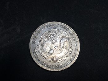 Close-up of coins on black background