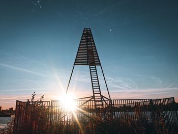 Low angle view of silhouette tower against sky during sunset