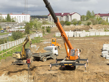 Construction site in city against sky