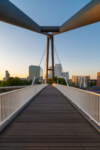Footbridge against clear sky