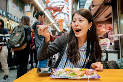 Woman having salmon in market