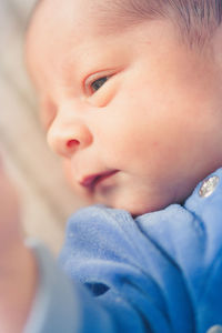 Close-up of cute baby boy looking away