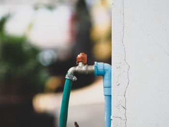 Close-up of faucet against wall outdoors