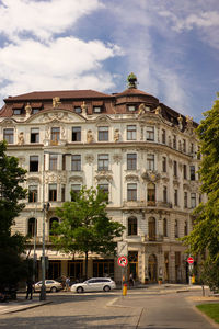 Building by road against sky in city