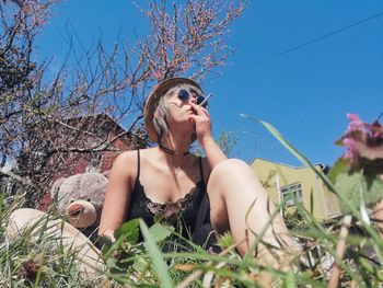 Full length of young woman against plants