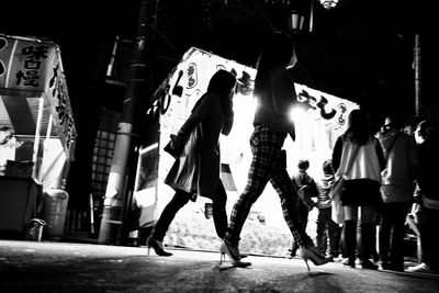 Low angle view of people walking on road