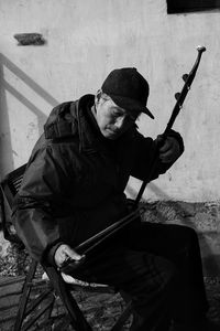 Side view of man holding camera