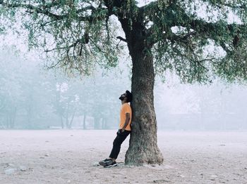 Rear view of woman walking on field
