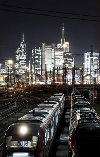 Trains against buildings at night