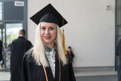 Portrait of woman wearing graduation gown