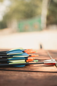 Close-up of multi colored arrows on table