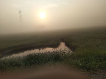 Scenic view of field against sky during sunset