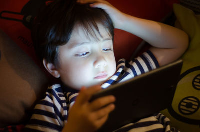 Close-up of boy using digital tablet