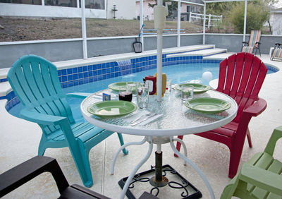 High angle view of chairs and table at swimming pool