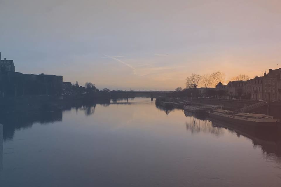 SCENIC VIEW OF RIVER BY CITY AGAINST SKY