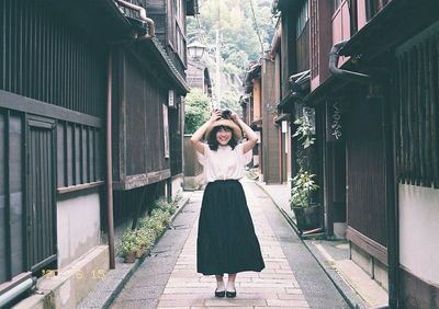 Full length portrait of woman standing