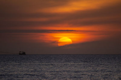 Scenic view of sea against romantic sky at sunset