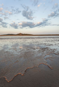 Scenic view of beach against sky during sunset