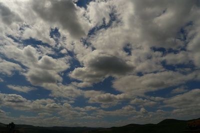 Scenic view of mountains against cloudy sky
