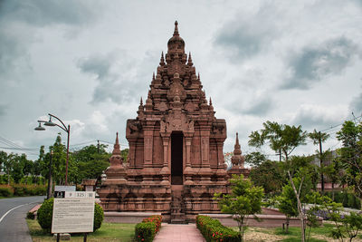 View of temple building against cloudy sky