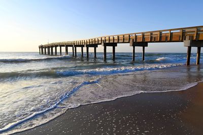 Pier over sea against clear sky