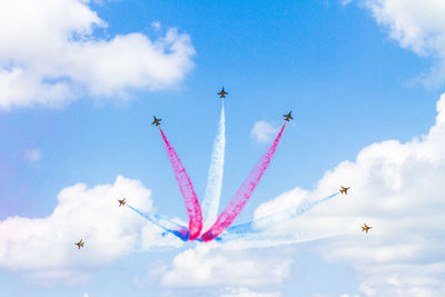 Low angle view of airplane flying against sky