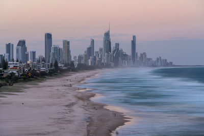 Modern buildings in city at sunset