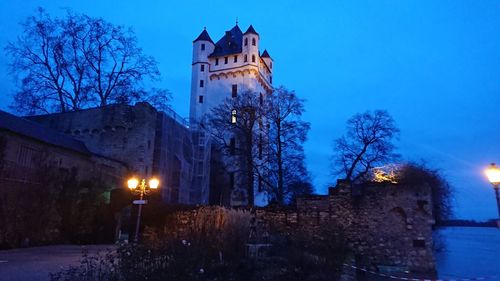 Low angle view of clock tower against sky at dusk