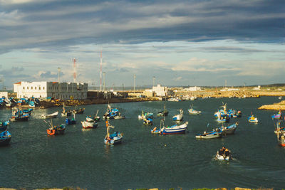 High angle view of sailboats moored in sea against sky